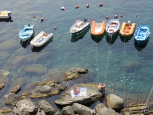 Lance and Anais sunning on the rocks in Riomaggori
